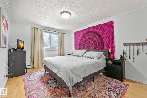 Room featuring light wood-finish flooring, white walls, and crown molding - 303 10165 113 Street, Edmonton, AB - Indoor Photo Showing Bedroom