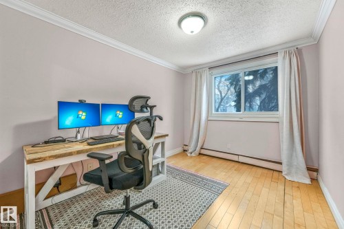 Room featuring hardwood-style flooring, white baseboards, and crown molding - 303 10165 113 Street, Edmonton, AB - Indoor Photo Showing Office