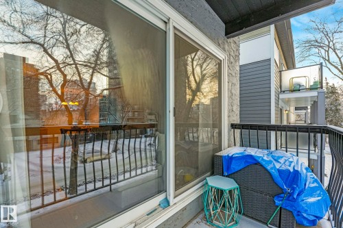 Private balcony featuring a sliding glass door entry and black wrought iron railings - 303 10165 113 Street, Edmonton, AB - Outdoor With Balcony With Exterior