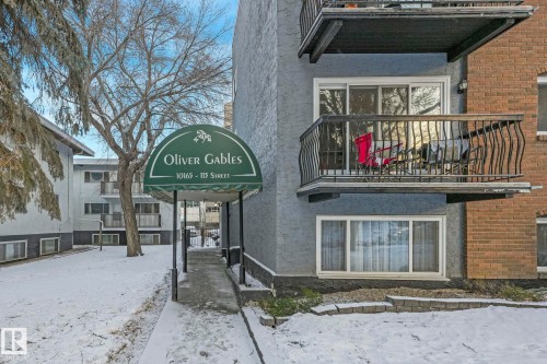 Oliver Gables building entrance featuring an arched green awning with signage - 303 10165 113 Street, Edmonton, AB - Outdoor With Balcony