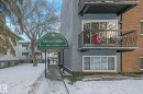 Oliver Gables building entrance featuring an arched green awning with signage - 303 10165 113 Street, Edmonton, AB  - Outdoor With Balcony 