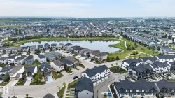 Aerial perspective showcasing a residential community with single-family homes and townhomes - 