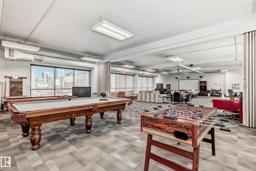 Spacious recreation room featuring two billiards tables and foosball - 706 10125 109 Street, Edmonton, AB 