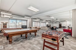 Spacious recreation room featuring two billiards tables and foosball - 