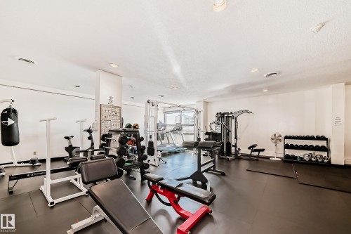 Dedicated fitness center featuring rubber flooring, recessed lighting, and multiple exercise stations - 706 10125 109 Street, Edmonton, AB 