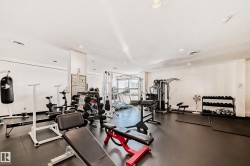 Dedicated fitness center featuring rubber flooring, recessed lighting, and multiple exercise stations - 