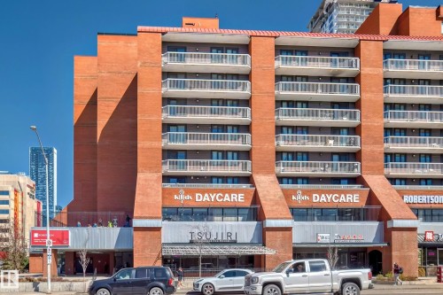 Multi-story brick building featuring multiple private balconies with glass railings - 706 10125 109 Street, Edmonton, AB 