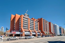 Multi-story building featuring a prominent brick exterior and multiple private balconies - 