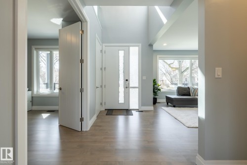 Foyer entrance with light wood-type flooring and recessed lighting - 10936 71 Avenue, Edmonton, AB 