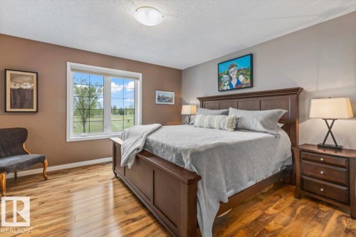 Window with exterior landscape, wood-finish flooring, and recessed ceiling lighting - 1086 Grantham Drive, Edmonton, AB 