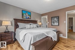 Spacious room featuring wood-finish flooring, two-tone painted walls, and white trim - 