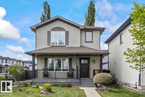 Two-story residential structure featuring light-colored siding and dark trim accents - 1086 Grantham Drive, Edmonton, AB 