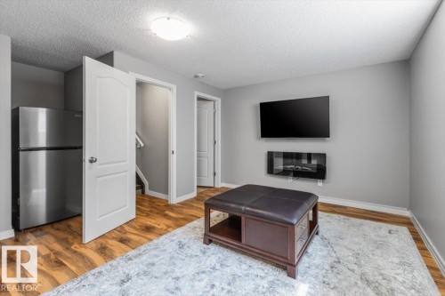 Living space featuring wood-finish flooring, light gray walls, and white trim - 1086 Grantham Drive, Edmonton, AB 