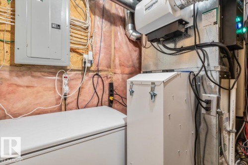 Utility space featuring a GeneralAire humidifier, electrical panel, and exposed insulation - 1086 Grantham Drive, Edmonton, AB 