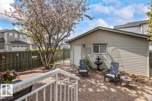 Paved patio area featuring brick-patterned pavers and a central flowering tree - 1086 Grantham Drive, Edmonton, AB 