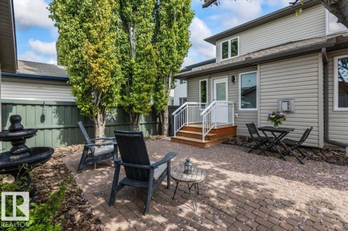 Paved patio area featuring brick pavers and a multi-tiered water fountain - 1086 Grantham Drive, Edmonton, AB 