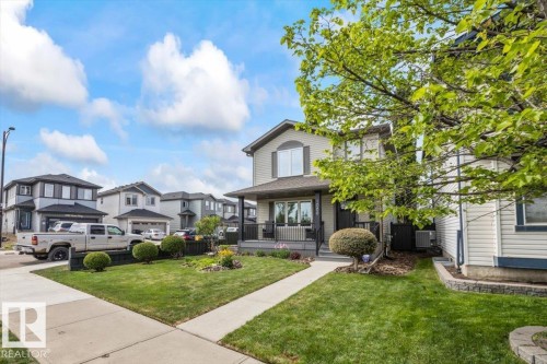 Two-story residence featuring light-colored siding and dark trim accents - 1086 Grantham Drive, Edmonton, AB 