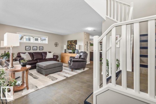 Open-concept living space featuring neutral wall tones and large format tile flooring - 1086 Grantham Drive, Edmonton, AB 