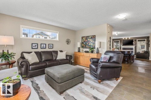 Open-concept living space featuring wood-finish flooring and a horizontal window - 1086 Grantham Drive, Edmonton, AB 