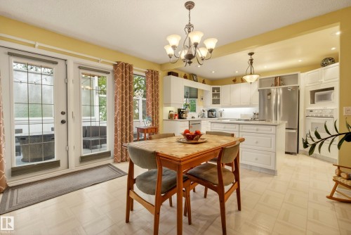 Bright dining area featuring French doors opening to an outdoor space, an open-concept layout, recessed lighting, and a chandelier - 78 Goodridge Drive, St. Albert, AB 