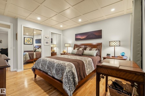 Bedroom featuring wood-finish flooring and a coffered ceiling with recessed lighting - 78 Goodridge Drive, St. Albert, AB 