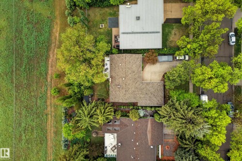 Aerial perspective showcasing a property with a brown shingle roof, concrete driveway, and mature landscaping - 78 Goodridge Drive, St. Albert, AB 