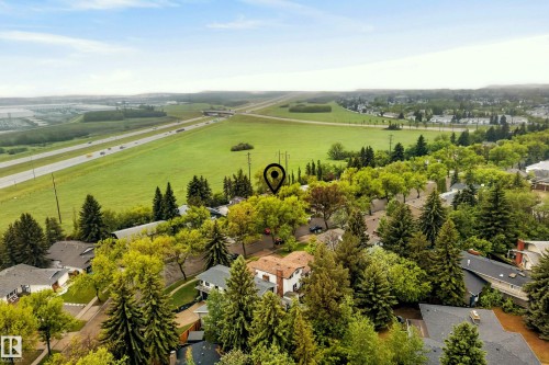Aerial perspective showcasing a residential area with varied rooflines and extensive tree canopy - 78 Goodridge Drive, St. Albert, AB 