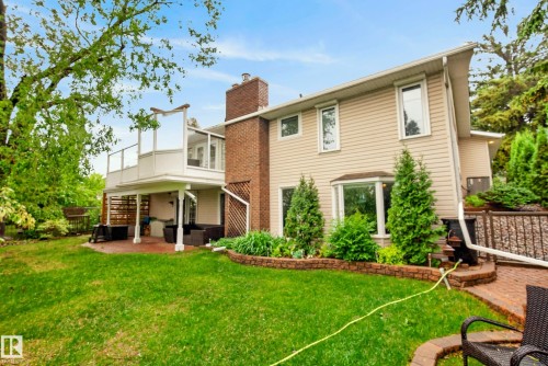 Expansive backyard featuring a manicured lawn, brick patio, and tiered landscaping - 78 Goodridge Drive, St. Albert, AB 