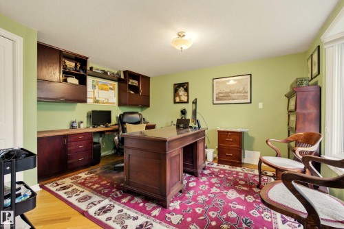 Dedicated office space featuring light green walls and wood-finish flooring - 78 Goodridge Drive, St. Albert, AB 