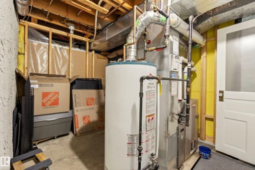 Utility area featuring a water heater, furnace, exposed ceiling joists, and concrete flooring - 78 Goodridge Drive, St. Albert, AB 
