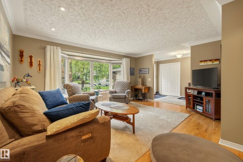 Bay window feature with expansive outdoor views, recessed lighting, crown molding, wood-finish flooring, and a double-door entry - 78 Goodridge Drive, St. Albert, AB 