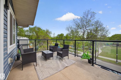 Private balcony featuring glass railings, a concrete floor, and horizontal siding - 12604 116 Avenue, Edmonton, AB 