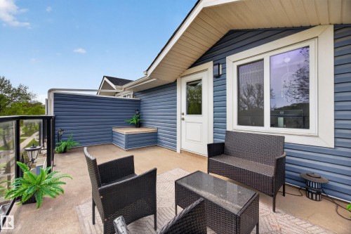 Outdoor patio area featuring blue horizontal siding and white trim - 12604 116 Avenue, Edmonton, AB 