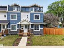 Contemporary townhome with blue siding, white trim, and stone veneer accents - 12604 116 Avenue, Edmonton, AB 