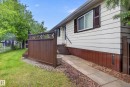 Exterior siding with contrasting foundation trim and dark window shutters - 21 Willowdale Drive, Edmonton, AB  - Outdoor With Exterior 