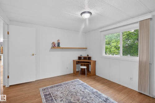 Bright room featuring wood-finish flooring and a large window - 21 Willowdale Drive, Edmonton, AB - Indoor Photo Showing Other Room