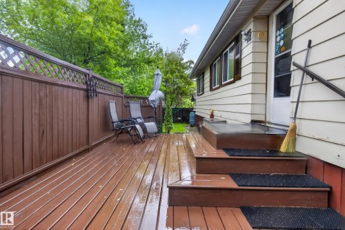 Spacious wood-finish deck with privacy fencing, multi-level design, and direct access to the property's exterior - 21 Willowdale Drive, Edmonton, AB - Outdoor With Deck Patio Veranda With Exterior