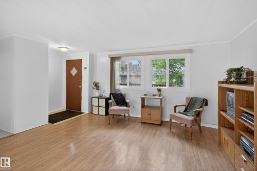 Living area featuring wood-finish flooring, white walls, and a white ceiling - 21 Willowdale Drive, Edmonton, AB - Indoor