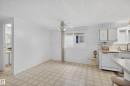 Kitchen area with white paneled walls, patterned tile flooring, and a ceiling fan - 21 Willowdale Drive, Edmonton, AB  - Indoor Photo Showing Kitchen 