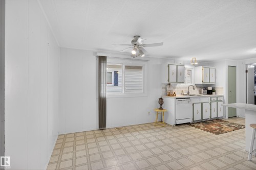 Open-concept kitchen area featuring white cabinetry, a double basin sink, and white appliances - 21 Willowdale Drive, Edmonton, AB - Indoor Photo Showing Kitchen