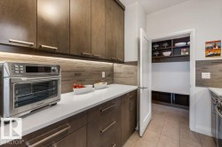 Secondary Main Floor Kitchen featuring Gas Stove, ample cabinet and counter space, and additional sink - 