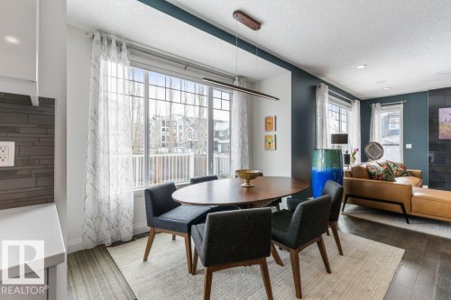 Open Concept Kitchen Eating Space featuring Dark Hardwood Flooring, Direct Access to Back Deck, and South Facing Windows - 4476 Suzanna Crescent, Edmonton, AB - Indoor Photo Showing Dining Room