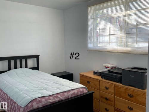 White walls and a large window with horizontal blinds define this room - 10017 113 Street, Edmonton, AB 