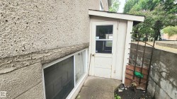 Exterior entry with a partial glass door and a covered stoop - 