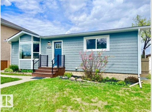 Light blue horizontal siding exterior with white trim - 4508 109A Avenue, Edmonton, AB 