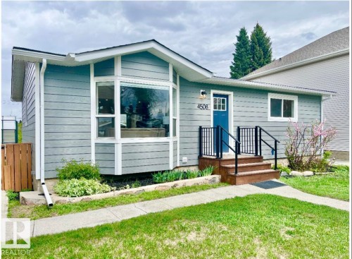 Light blue horizontal siding exterior with a prominent bay window - 4508 109A Avenue, Edmonton, AB 