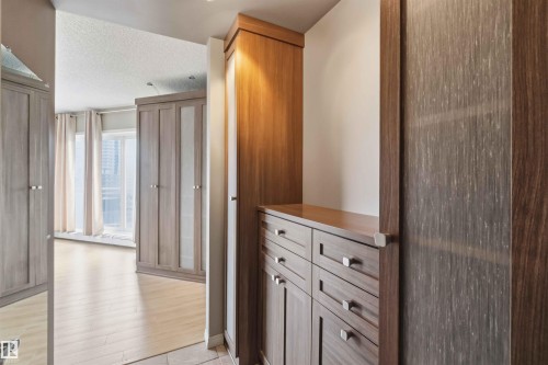 Integrated wood-finish cabinetry featuring varied tones and textures - 901 10504 99 Avenue, Edmonton, AB 