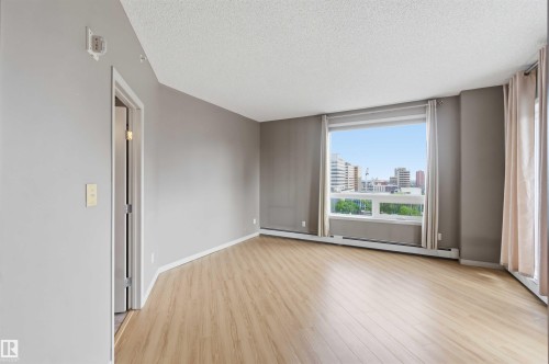 Light wood-finish flooring complements muted wall tones - 901 10504 99 Avenue, Edmonton, AB 
