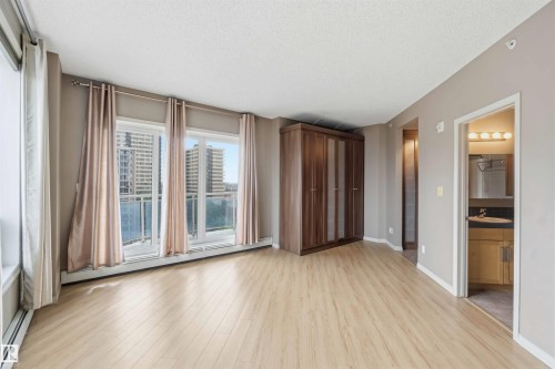 Light wood-finish flooring complements neutral wall tones - 901 10504 99 Avenue, Edmonton, AB 