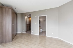 Spacious room featuring wood-finish flooring and neutral wall tones - 